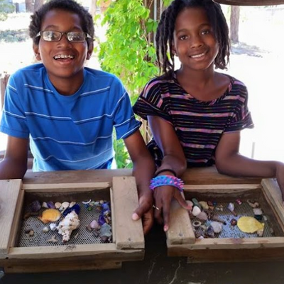 children showing their seashell treasure